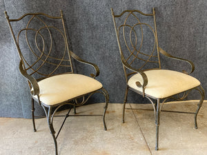 Pair of Wrought Iron Armchairs With Cream Upholstered Seats.