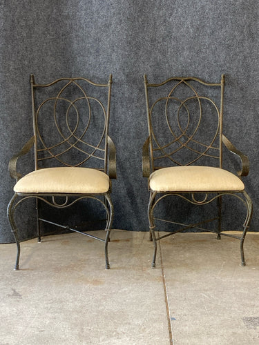 Pair of Wrought Iron Armchairs With Cream Upholstered Seats.